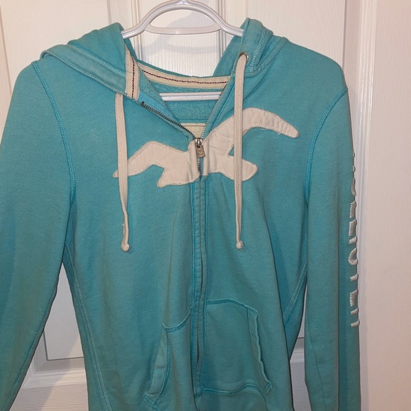 Holister zip up hoodie. Size large fits small. Light blue with white embroidery.